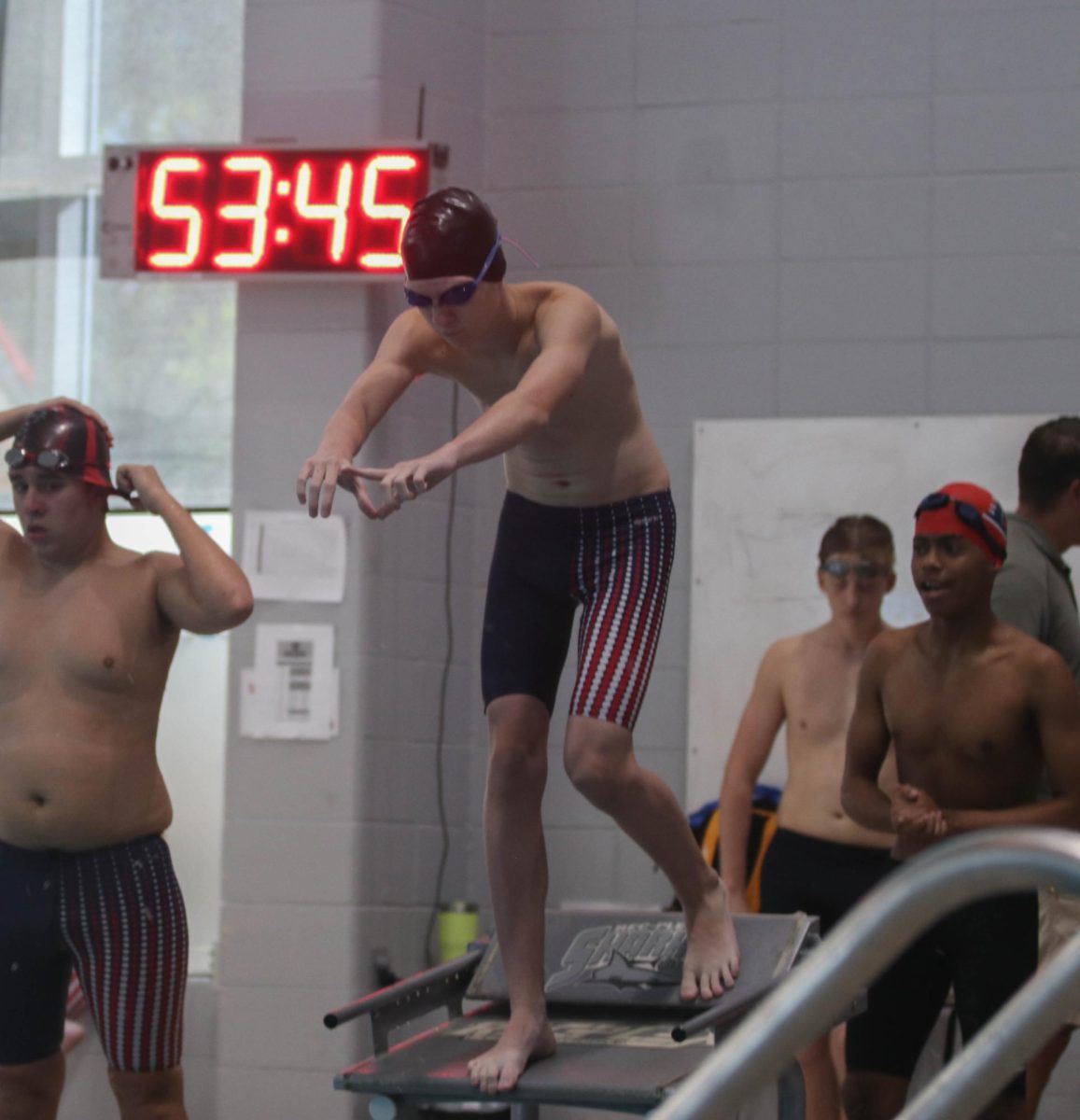 Benjamin Wibbenmeyer waits in start position for freestyle relay race after Jimenez Turner at RecPlex relay meet on Oct. 5.