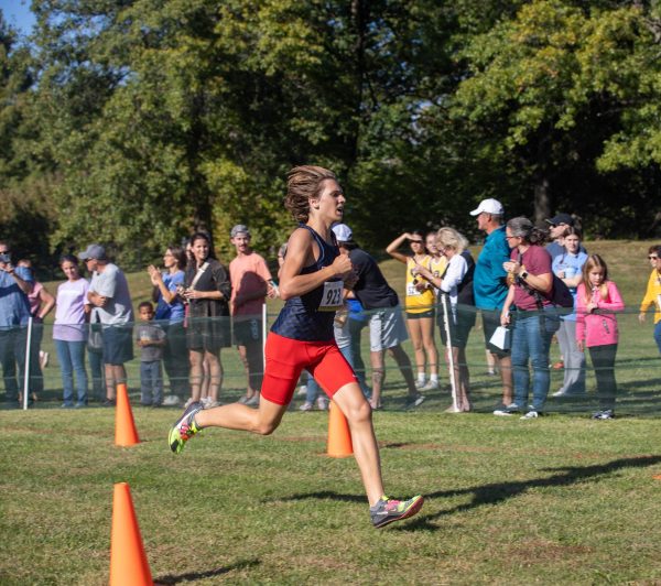 Junior Ayden Taylor runs to the finish line at the GAC competition. Taylor placed second in the varsity boys race with a time of 16 minutes and 26 seconds.