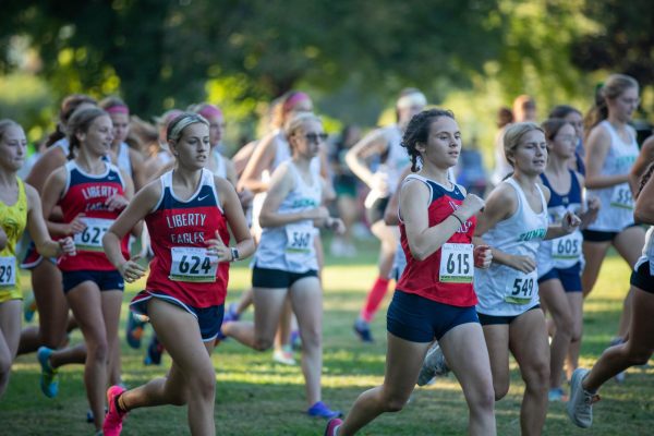 During the GAC conference held on Oct. 12, junior Molly Mueller and senior Maggie Barnett race towards the finish line.