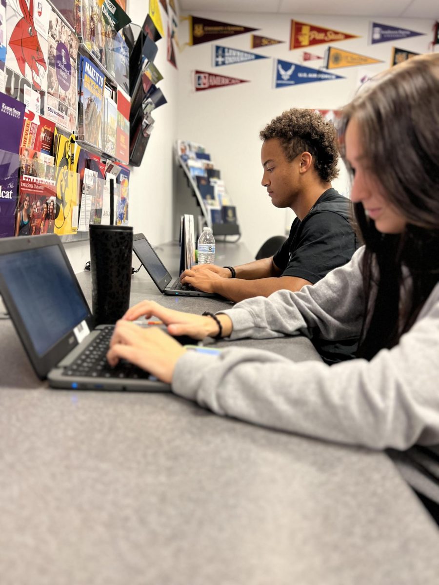 Aidan Summers and Grace Howard work on college applications in the Student Center. During Apply Month, seniors go to the counselors office to receive help on their applications.