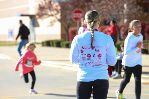 Lucy Lant hands medals to Kids Fun Run participants at the Lucy Strong Charity Run on Nov. 18.