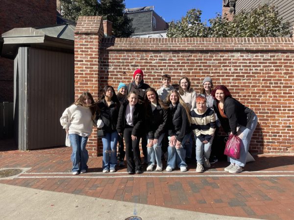 Eleven students involved in publications pose outside the Paul Revere House in Boston, Mass. to learn more about the history of the city. 