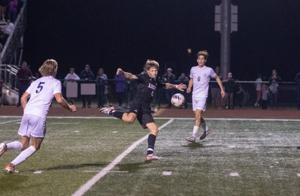 Senior Layton Dahl winds back, attempting to volley, misses and instead passes to Senior Brady Freeman, positioned just out of frame. 