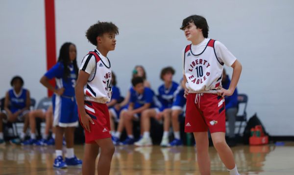 Bryson Breadsley (left) and Mason Graham (right) talk before tip-off against Lutheran High School.