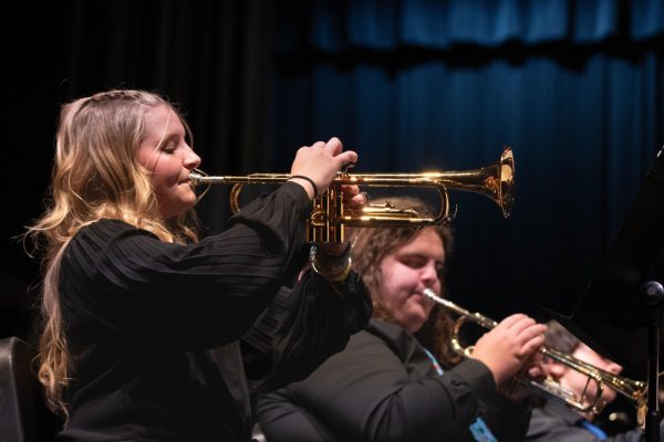 Sophomore McKenzy Akers plays trumpet during the annual winter band concert that was held on Dec. 5 in the auditorium. An array of classic holiday and Christmas songs were played by both concert and jazz band. 