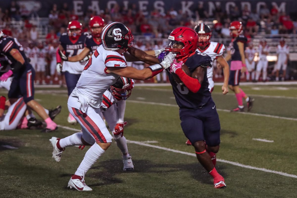 Senior Marquis Williams (#8) holds the face mask of Fort Zumwalt South senior Chase Bensing  (#5). The Eagles won over the Bulldogs, 34-33. The pink-out football game was held to raise money for breast cancer awareness through quarterly miracle minutes. This photo stood out to me, despite its lack of complete clarity, the strong grab Williams had on Bensing was nothing short of impressive. 