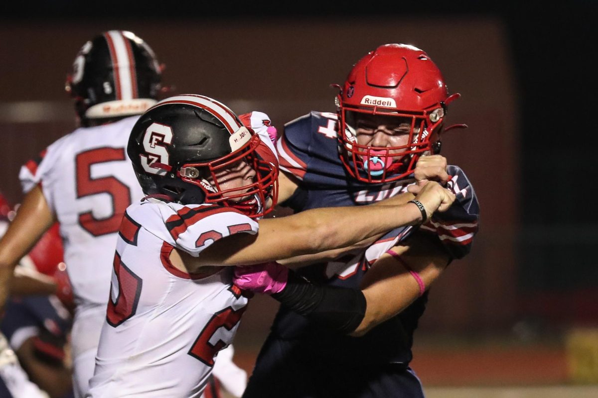 Senior Aidan King (#94) takes hold of a Fort Zumwalt South Bulldog in a game held on Sept. 29. This photo has so much emotion held behind, with tension still rising as the game was nearing its end. The Bulldogs were within 1 point, trailing 34-33 late in the fourth and decided to go for a two-point coversion for the win. However, they were stopped by the Eagles defense and they prevailed 34-33. 