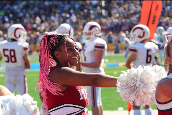 Jada Greer cheers in the warm weather of fall at a MICDS away football game. (submitted by Morgan Macam)