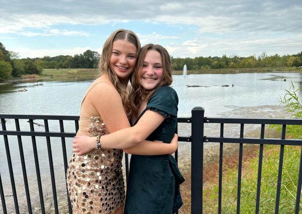 Lily (on the left) and Olivia (on the right) pose in their homecoming dresses on the bridge at Broemmelsiek Park.