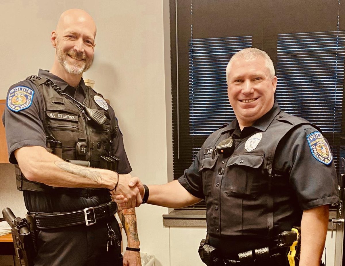 Officer Will Stern (left) and Officer Matt Wagner shake hands on Wagners last day as an SRO at Liberty.  