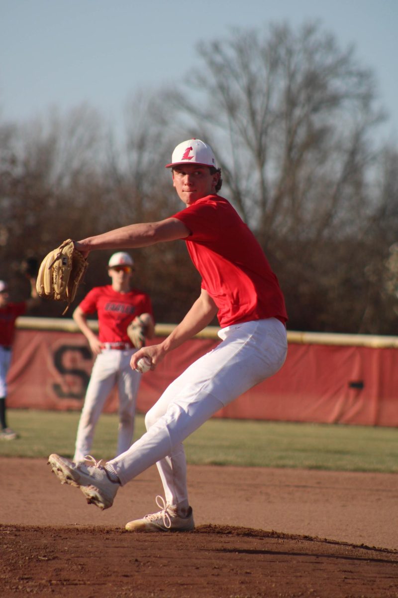 Senior Ty Holman practices his pitch during the first week of spring sports.
