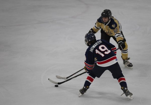Sophomore Greyson Howard gains control of the puck while during a game  on Jan. 9. against Holt. 