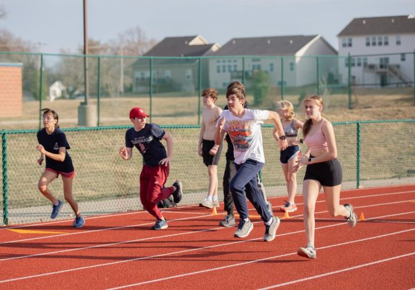 Distance runners run drills during the second day of track and field practice. 