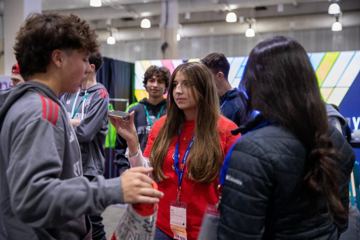 Bella Romine interviews a student attending the Fall 2023 NSPA/JEA Convention held in Boston, Mass.