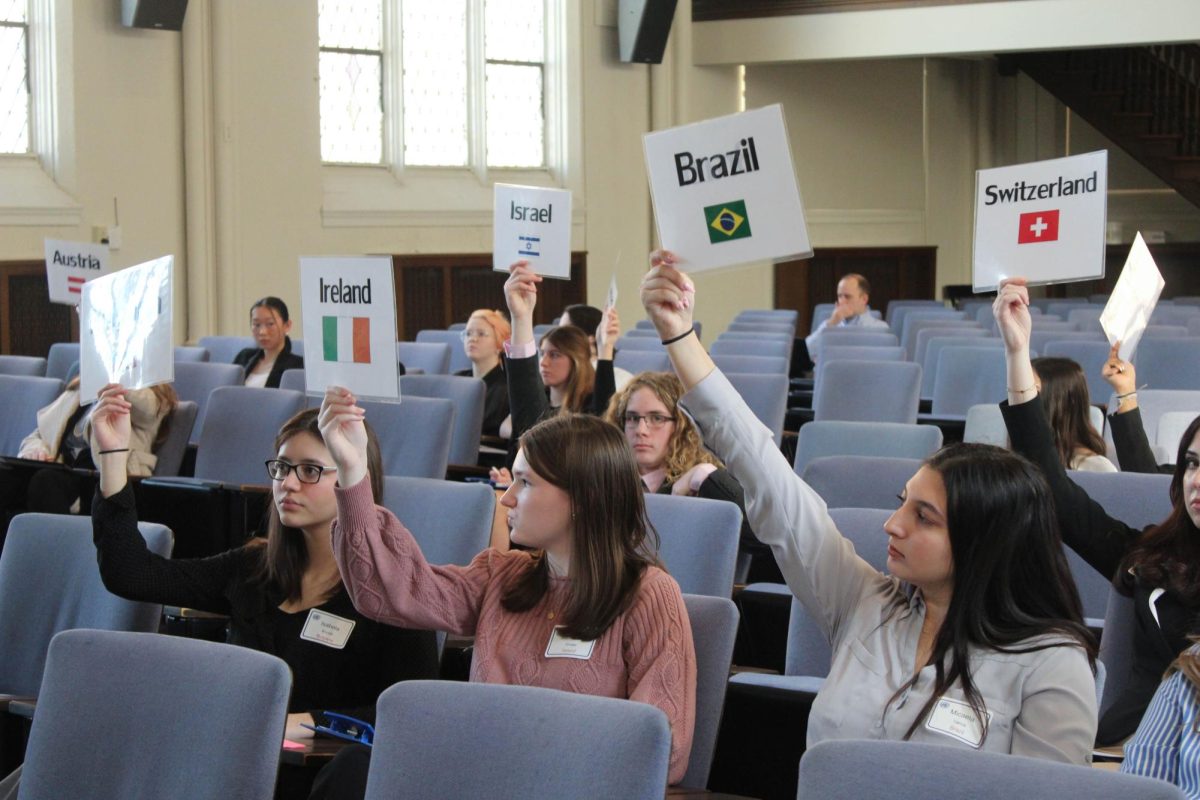 Students hold up signs that represent their countries 