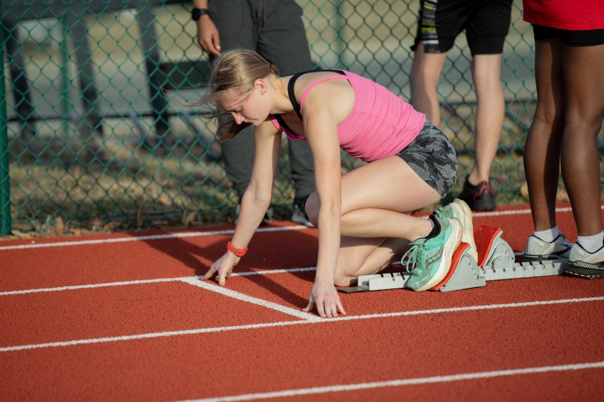 Senior Caitlin OMara places her hands on the track to prepare herself for the start of field and track tryouts. 