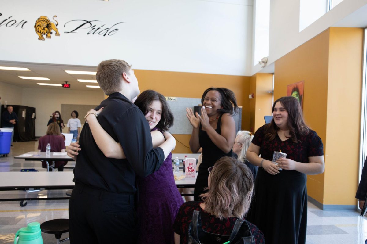 Senior Emina Topcagic hugs junior Brandt Cleppe after finding out her vocal solo performance was rated as exemplary on March 2. This ranking is the highest ranking, and means that she will go on to compete at the state level on April 26. 