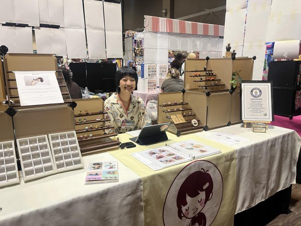 Ruby Huang poses for a photo at her booth during Anime St. Louis.