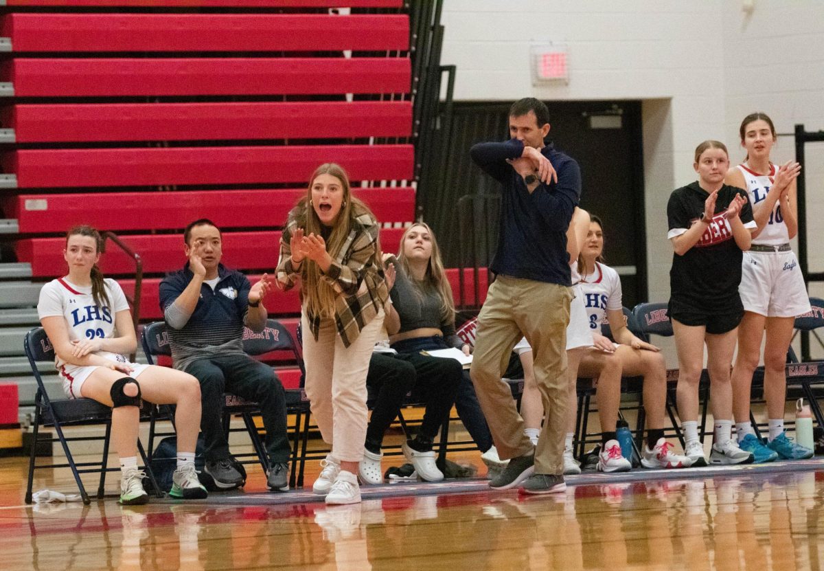 Savannah Kruse cheers on the sidelines during a girls basketball game during the 2022-2023 season