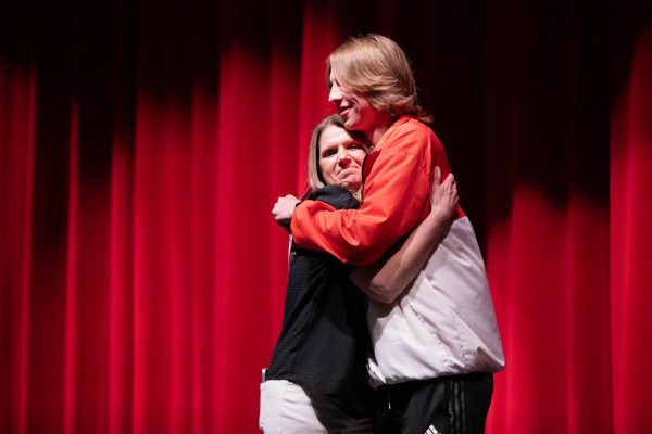 Senior Cohen Waldren hugs Robyn Taylor after receiving the Liberty Legends Award