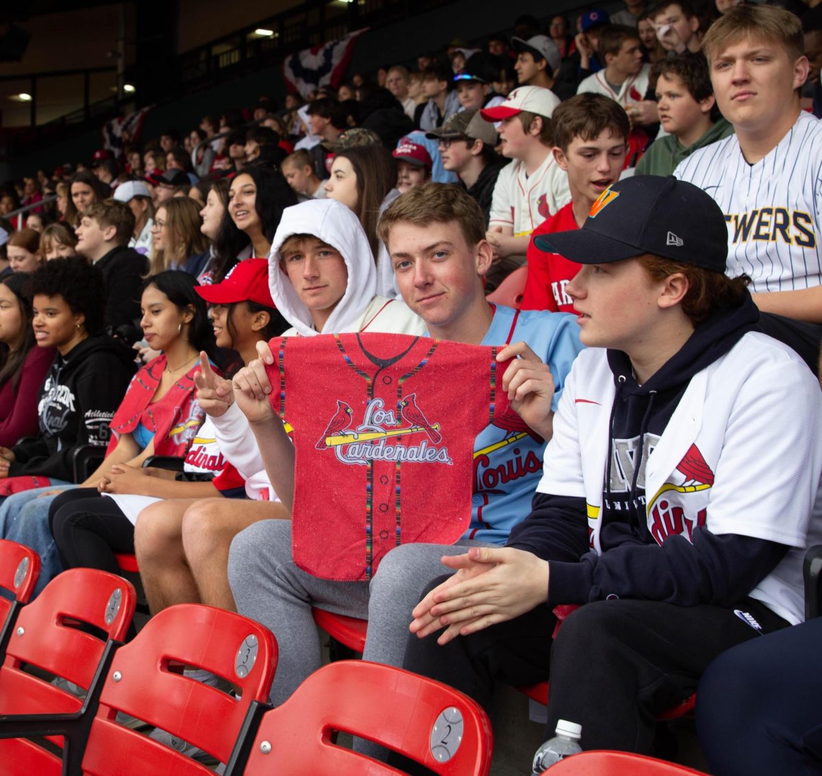 Junior Owen Witte shows the free jersey towel students received that says Los Cardenales. 