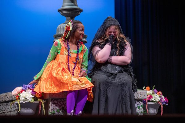 Senior Grace Edney, who performs as Feste, sits down next to Countess Olivia, played by sophomore Mak Barnes, as she grieves the loss of her brother. 