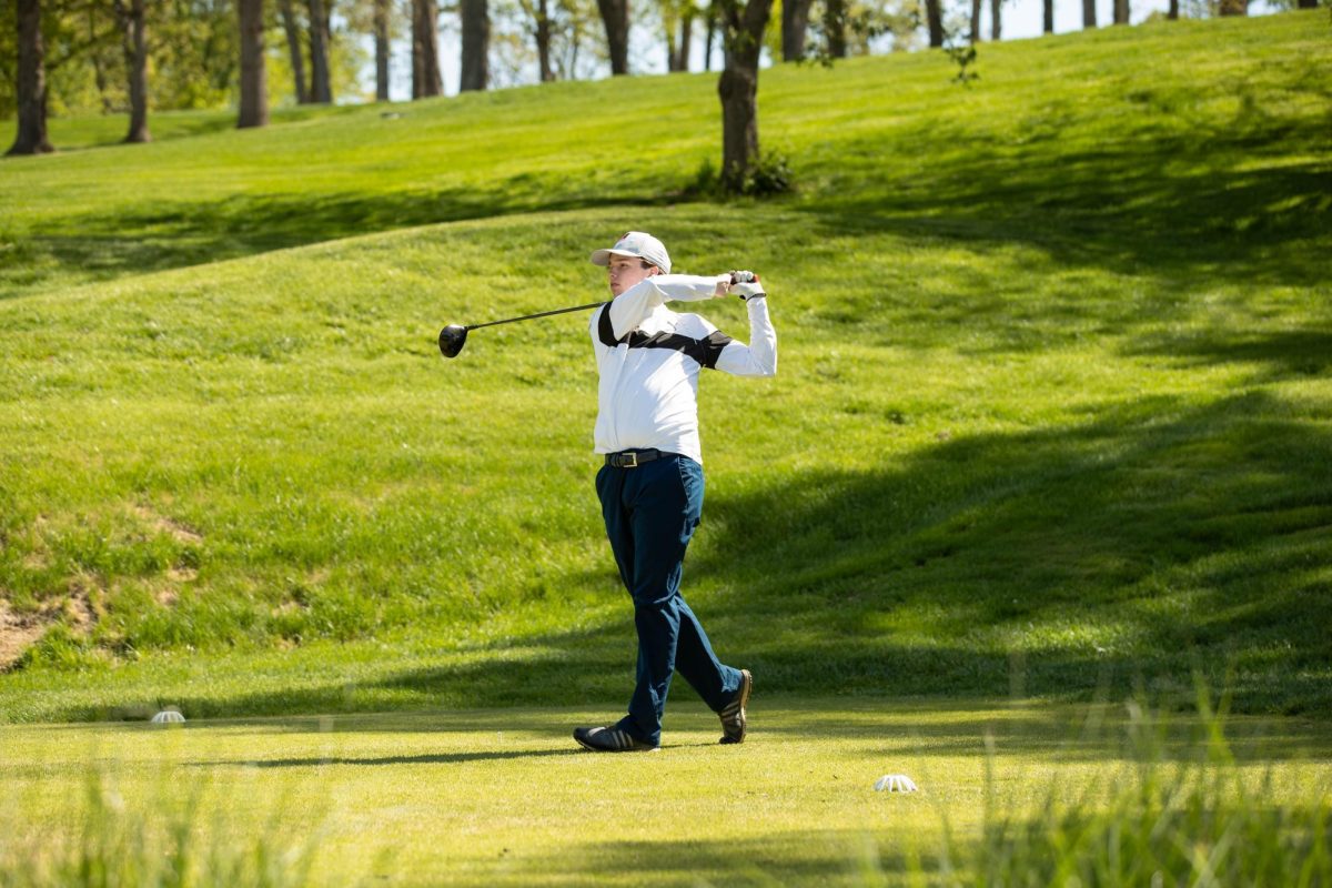 Senior Carter Ashby watches as the golf ball soars in the air out of frame during a  four-way tournament held on April 19.  