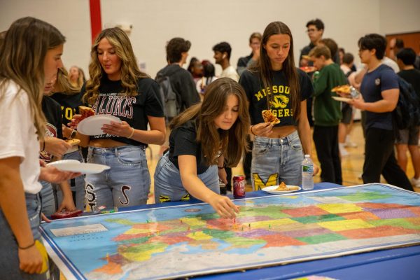 During National Commitment Day, senior Isabella Gamm places a pin on the map to show where she will be attending in the fall. Gamm will be attending Mizzou this coming fall. 