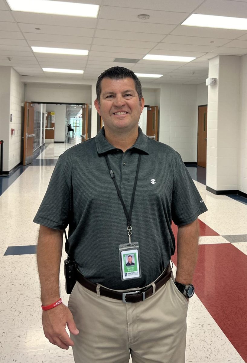 Mr. Pryor stands at the beginning of the 300 Hallway during Soar Time. 