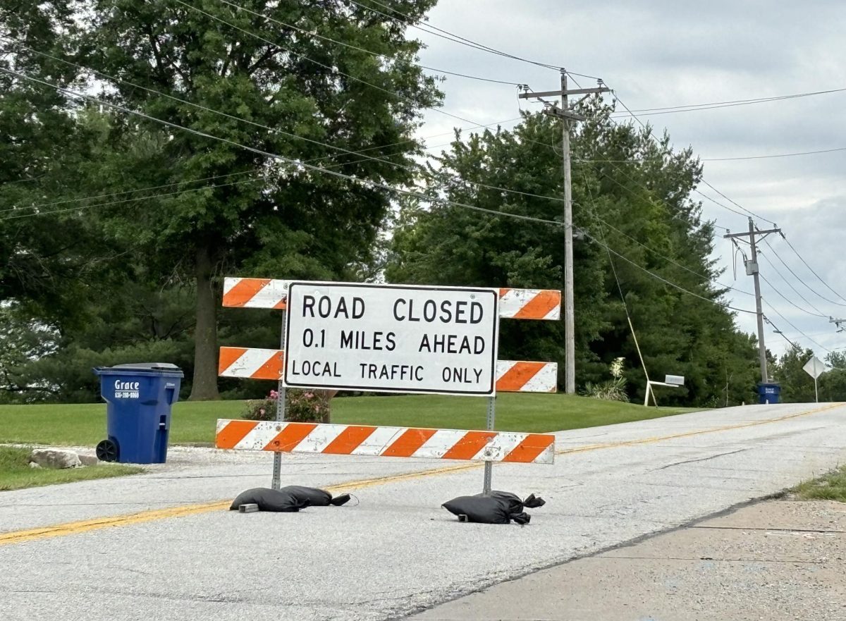 A road closure sign redirects cars north of Orf Road on Duello Road. 