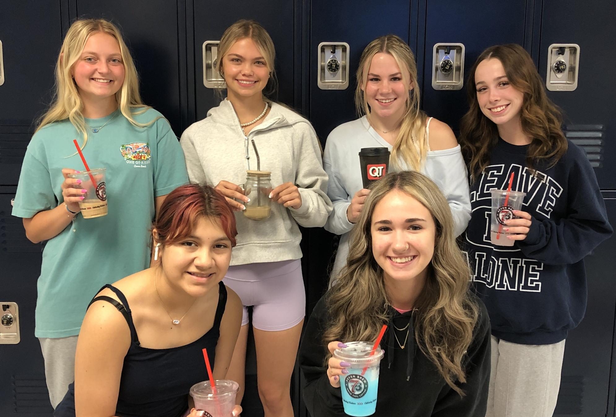 Students pose with the various coffees that they brought to school. 