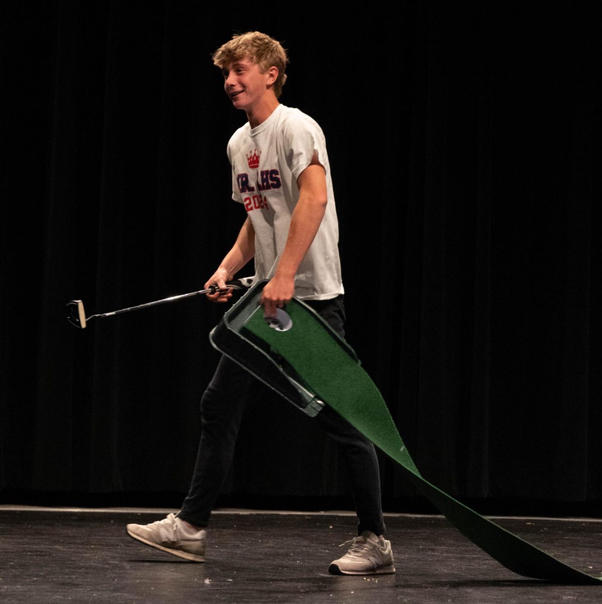 Jack Gnandt walking off stage after showing off his golfing skills for the talent show segment.