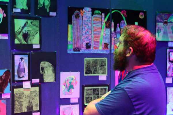 A show visitor enjoys glow-in-the-dark artwork on May 4.