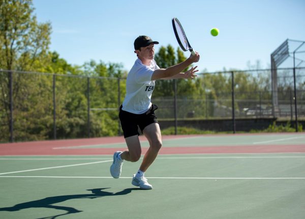 Ben Wiley strides to the ball during the varsity tennis GACs.