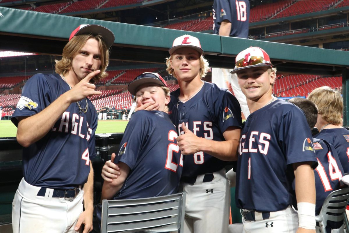 Cohen Waldren, Cooper Freand, Jake Greer, and Austin Capizzi enjoy the view from the Cardinals dugout. 