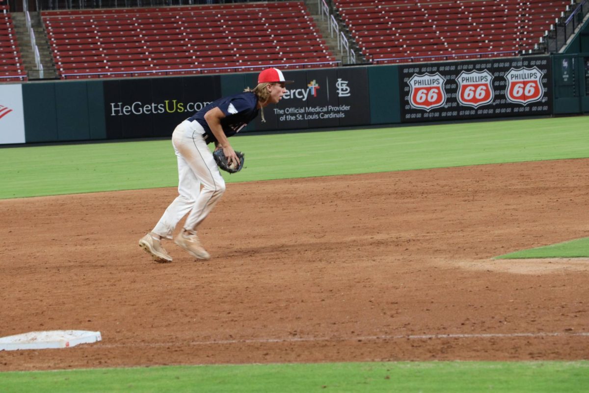 Cohen Waldren (12) gets ready to field a grown ball from third base.