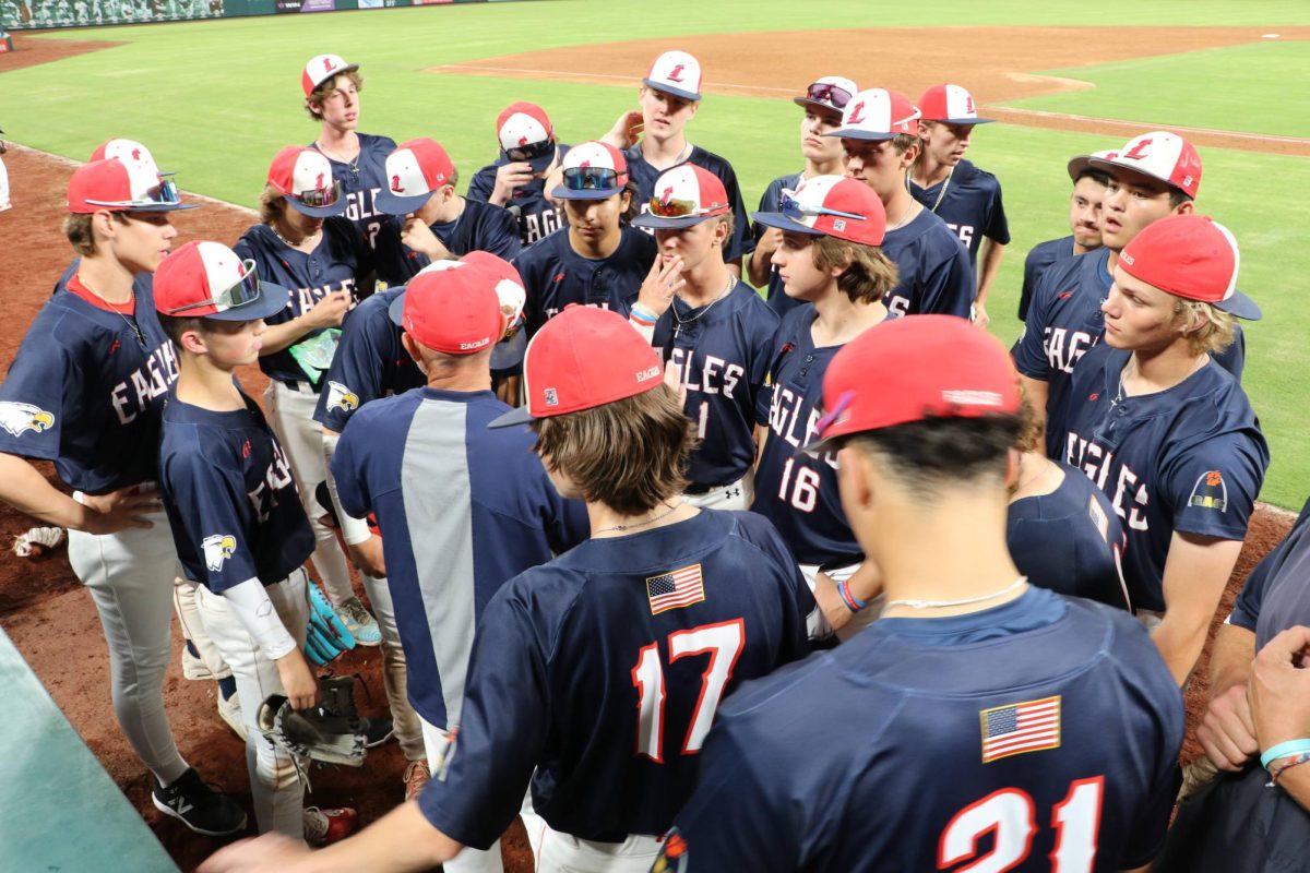 Varsity Eagles huddle after the seventh inning to close out the game. 