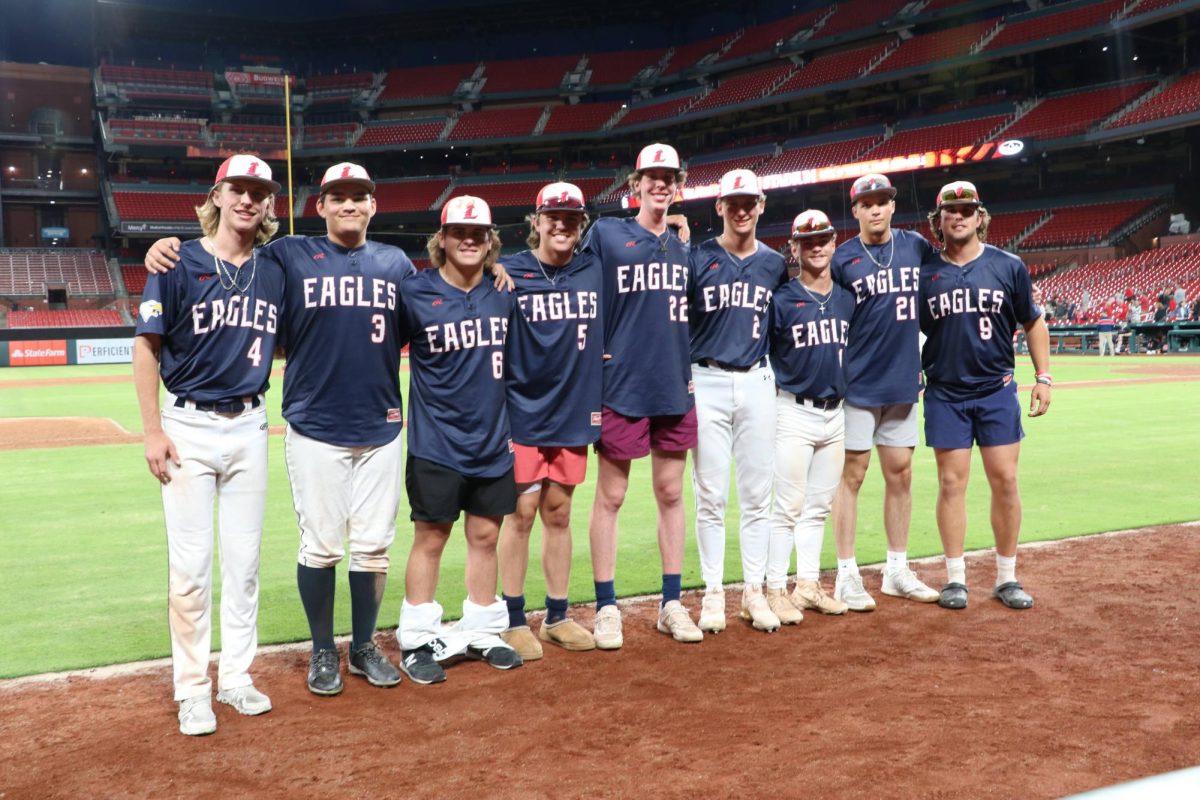 Seniors Cohen Waldren, Lincoln Ralls, Drew Smith, Alex Jung, Brayden Schnurbusch, Ty Holman, Austin Capizzi, Lincoln Rockette and Noah Kuehner stand on the field one last time. 