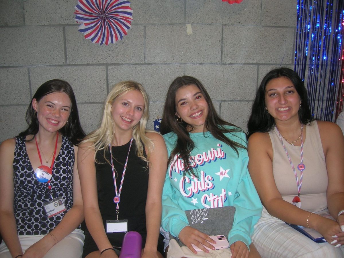 Margot Revelle (12), Cadence Benson (12), and Micaela Garcia (12) pose for a picture with a friend made at Girls State.