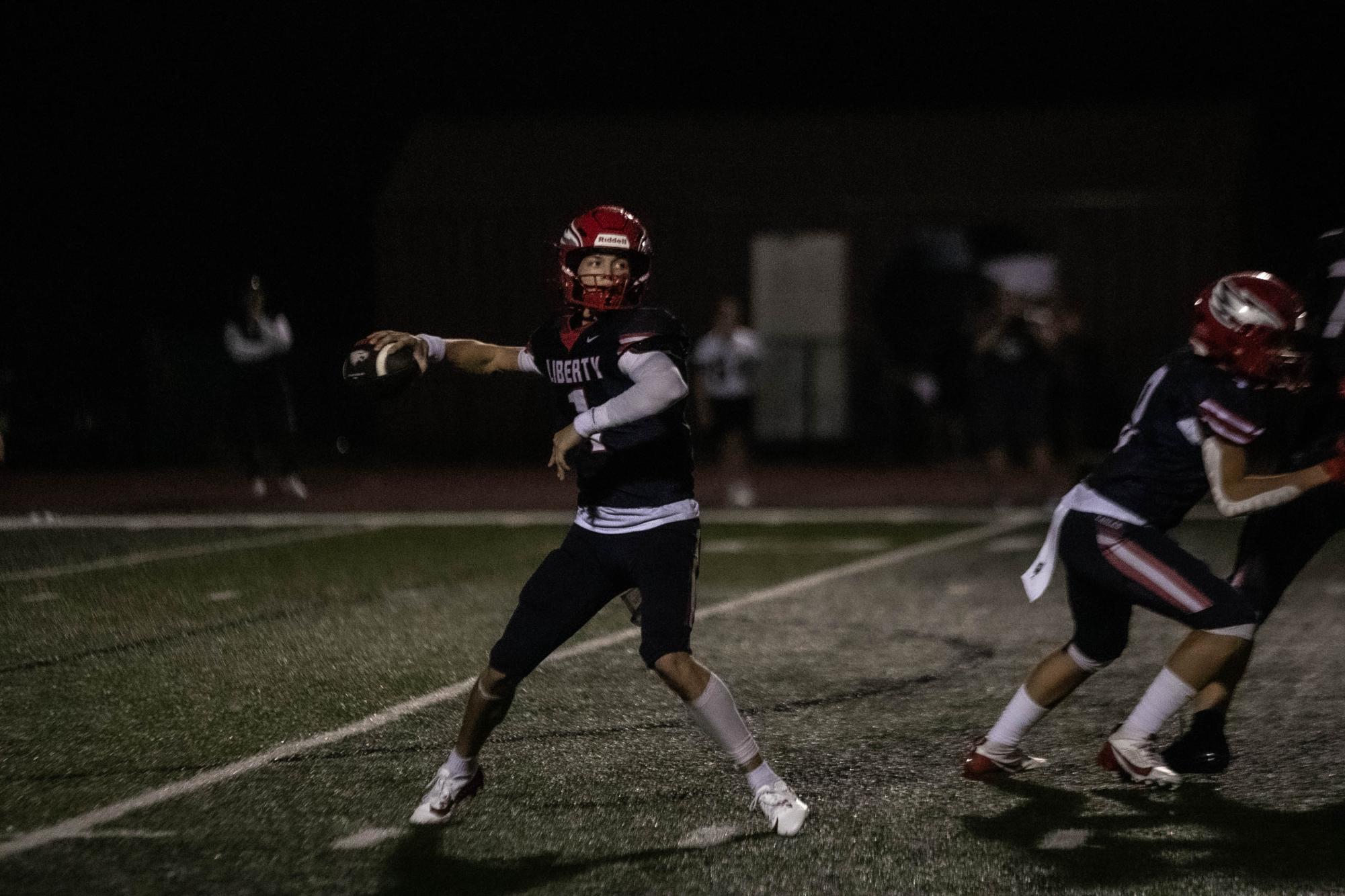 Cody McMullen (12) gets ready to throw the ball to wide receiver on the field during the game on Friday, Aug. 30.