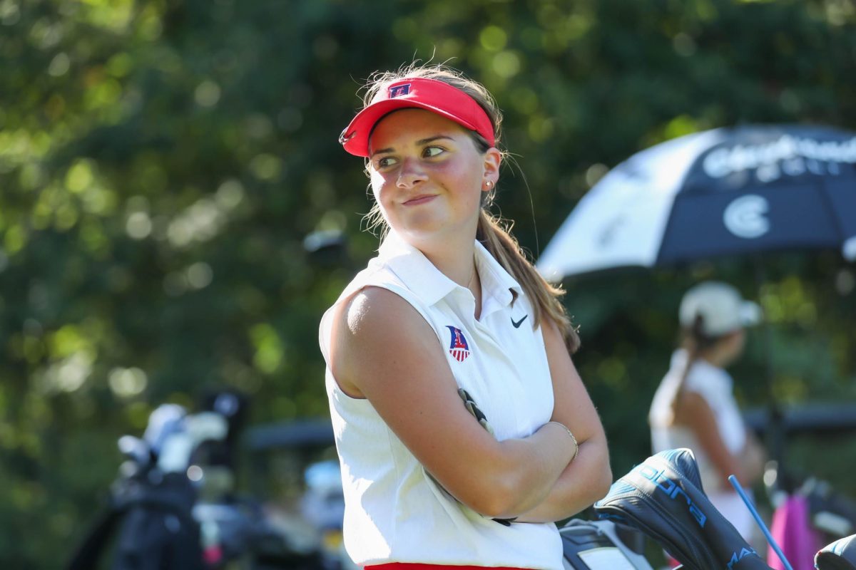 Emerson Stubblefield (11) looks off to the side smiling to her teammate during the golf match against Troy Buchanan on Sept. 5.