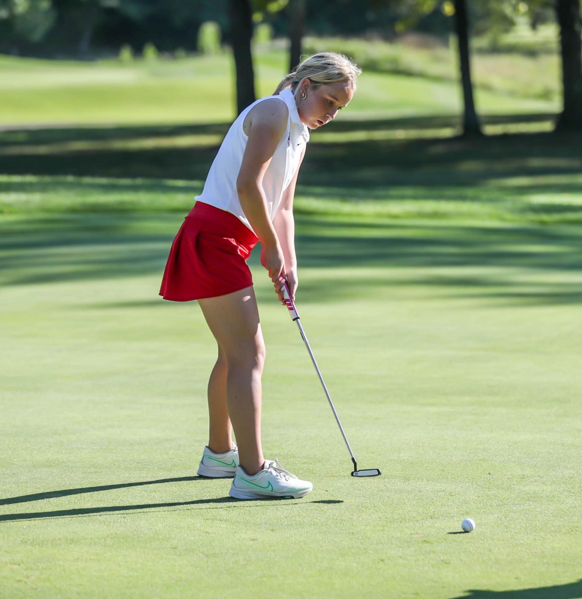 Morgan Buckley (9) putts her ball to the hole in match against Troy Buchanan.