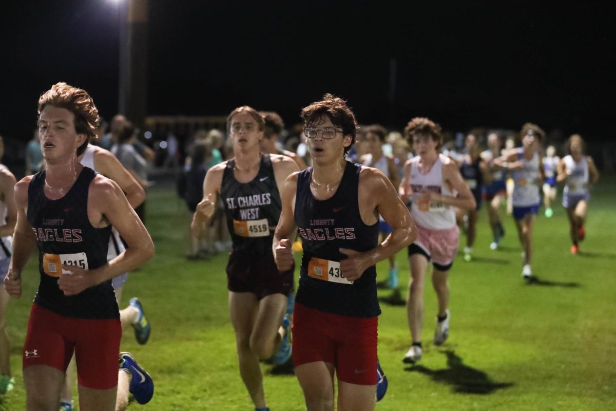 Owen Greer (11) and Tyler Besowshek (11) run together to finish line at Twilight meet.