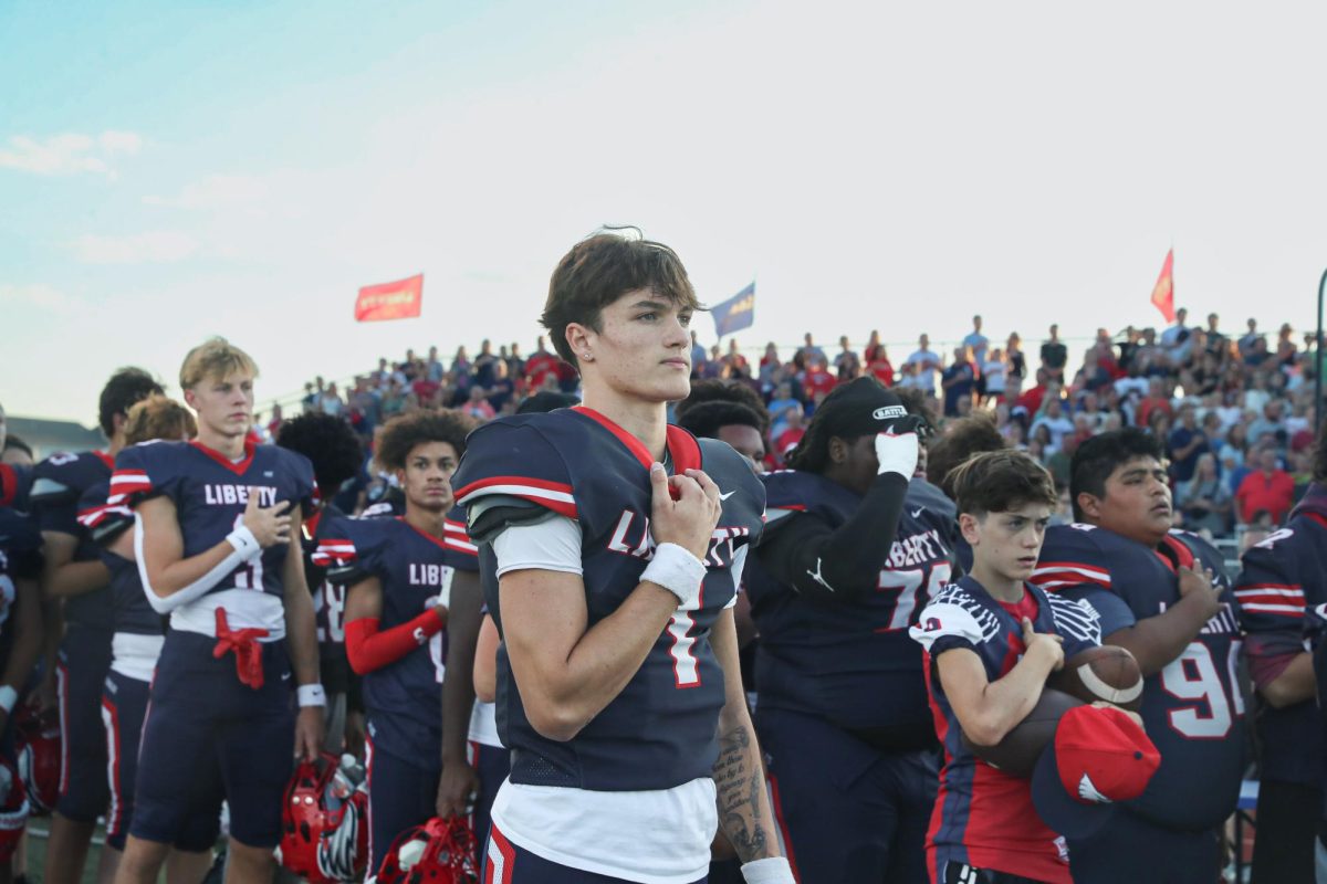 Quarterback Cody McMullen (12) stands for the national anthem before the game.