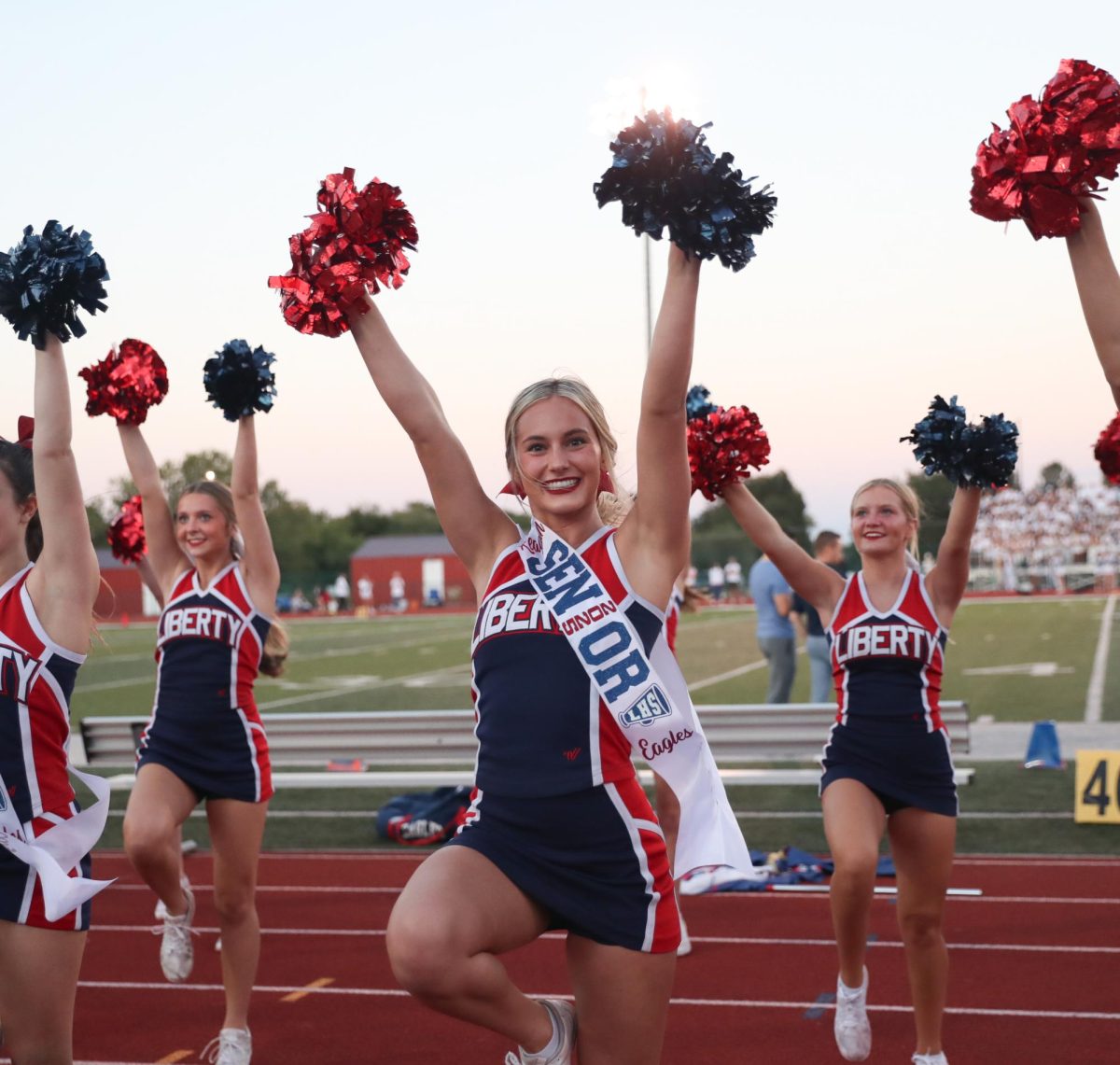 Reagan Bone (12) smiles as she cheers on the sidelines.