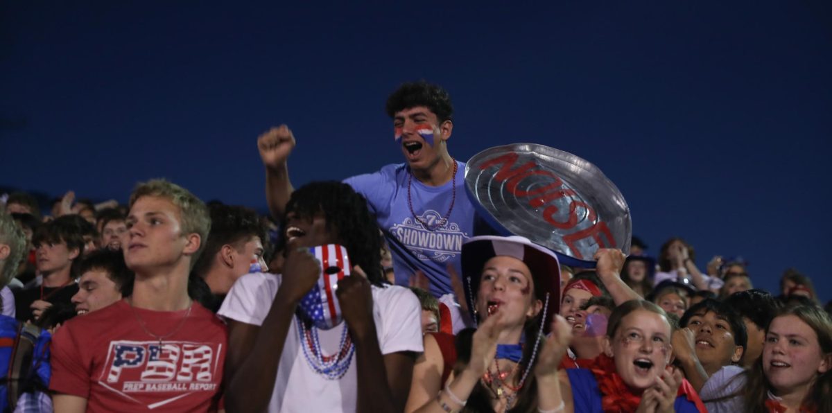 Andrew Badra (12) cheers while holding the spirit can lid as Liberty wins the game against Timberland, 44-34.