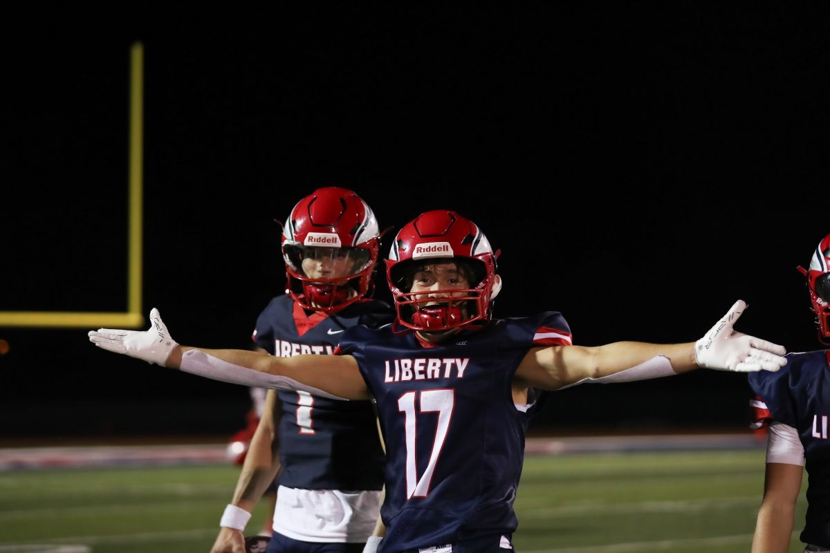 Caleb Orcutt puts his arms out in celebration while Cody McMullen looks in the victory against Timberland.