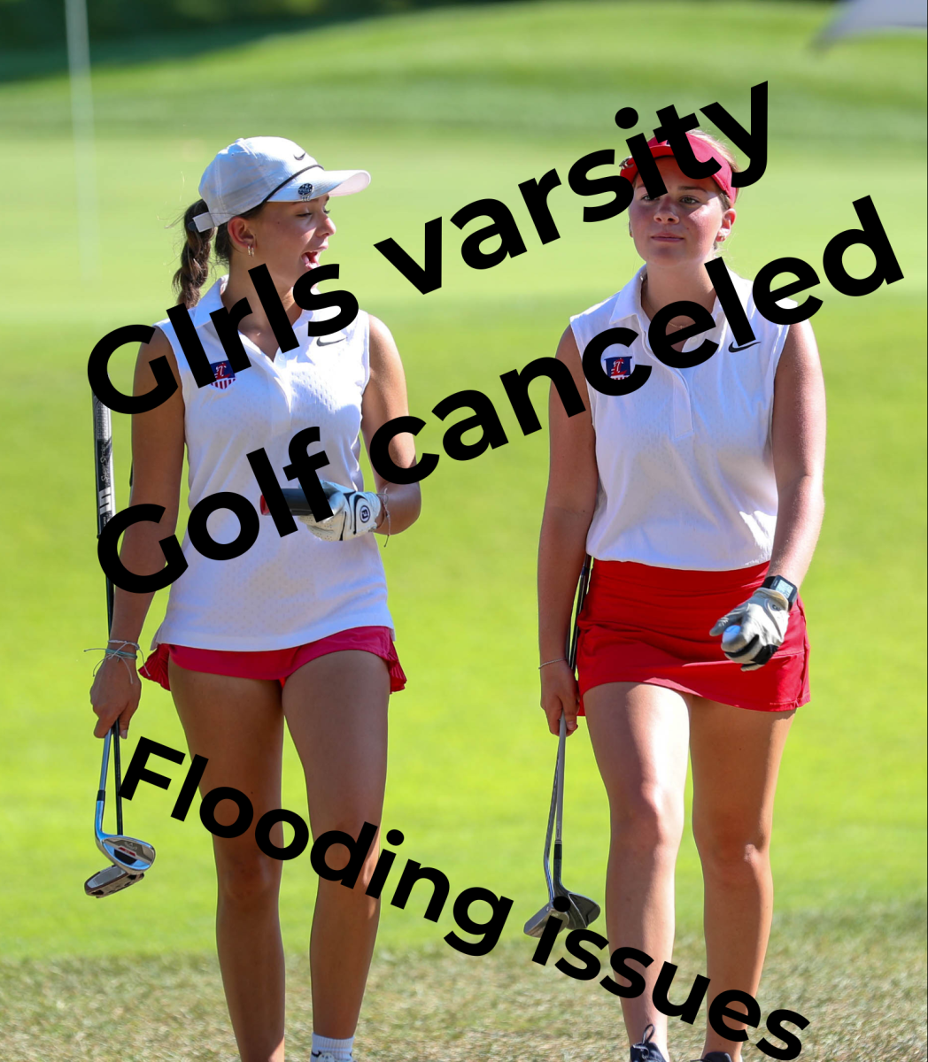 Two varsity members in girls golf walk off the green during a match earlier this season.