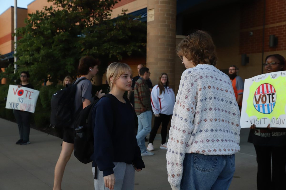 Clara Walker (12) talks to Nola Duenwald (11) about registering to vote and reasons to vote.