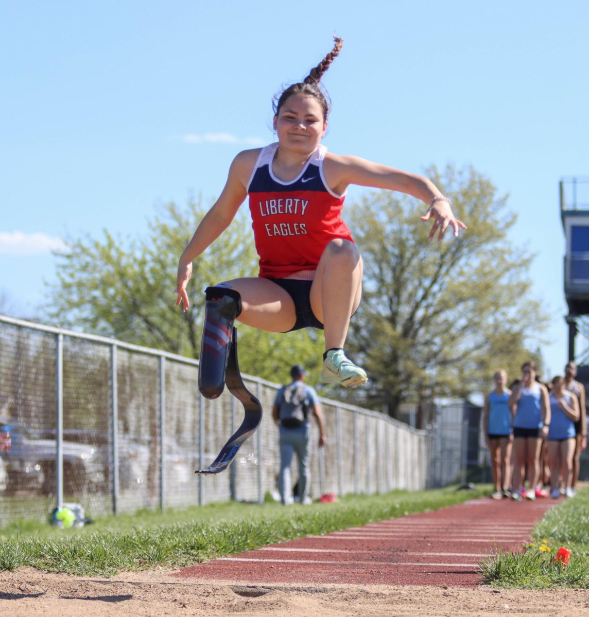 Vazquez participating in long jump her senior year at a track meet.